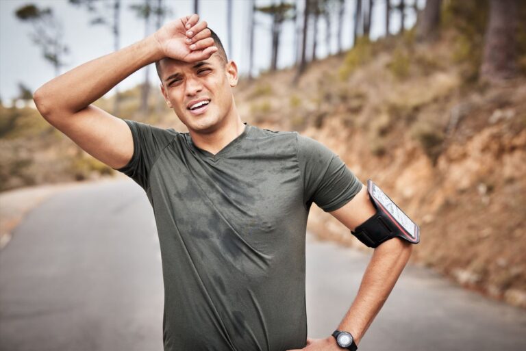 Man catching his breath post-run, highlighting possible side effects of Sermorelin peptide.