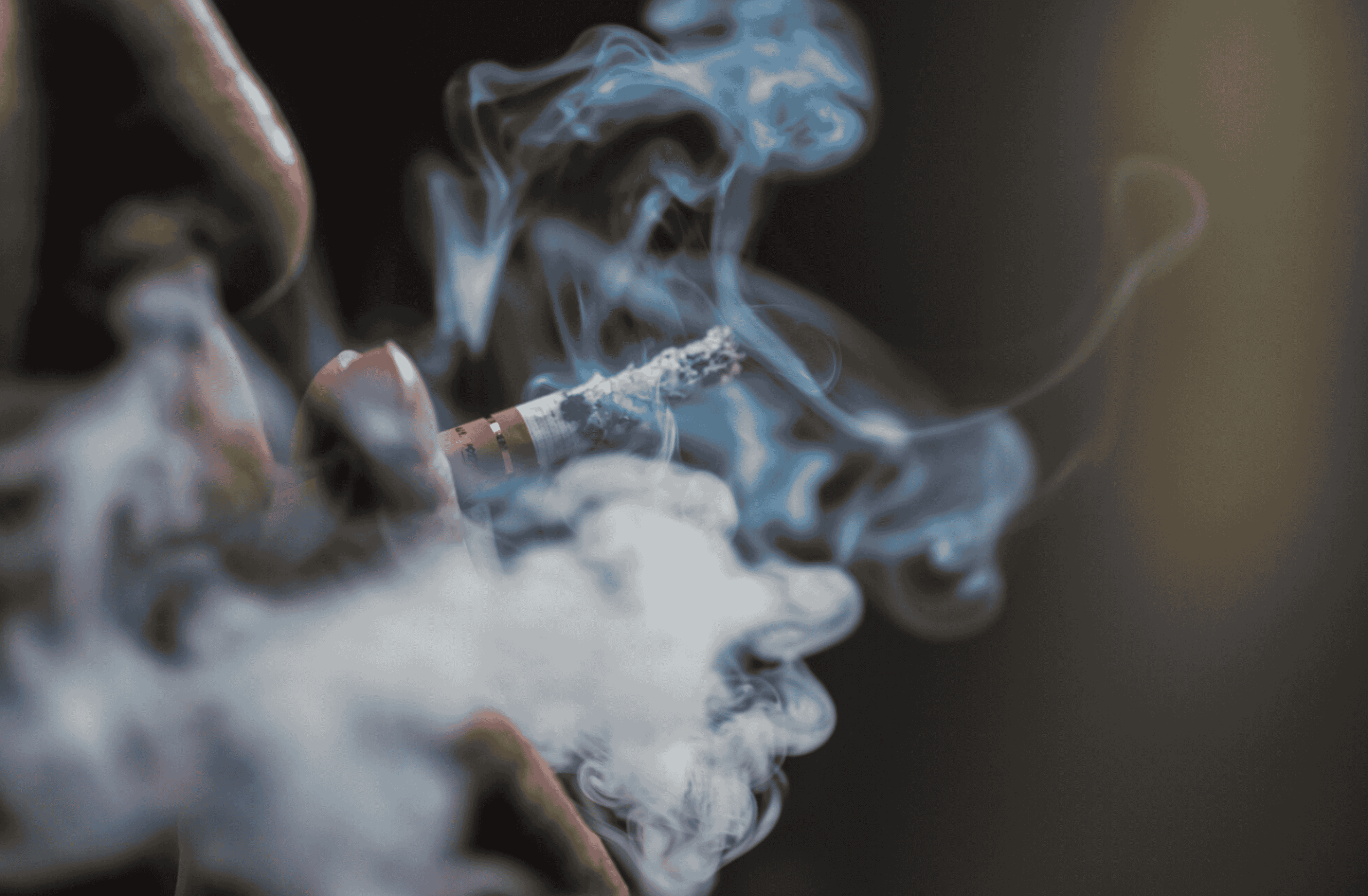 Man smoking a cigarette, contemplating whether nicotine increases testosterone.